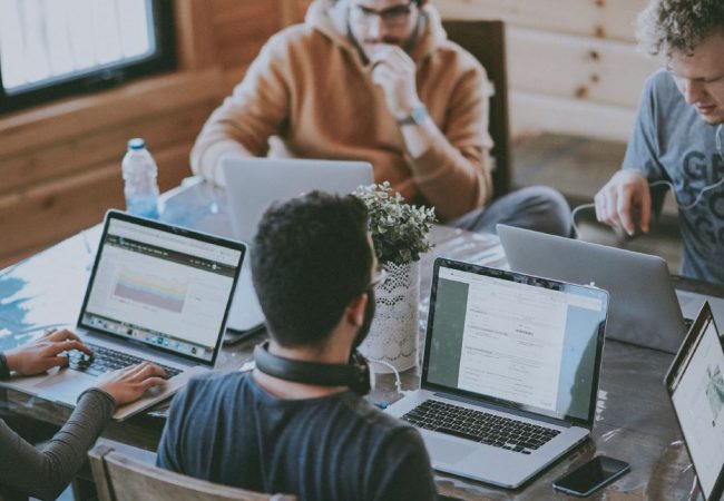 Coworkers working on computers in open work space