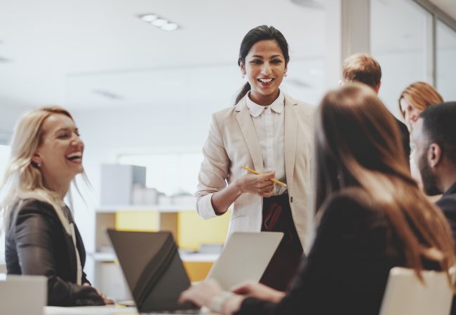 Diverse coworkers gathering at office