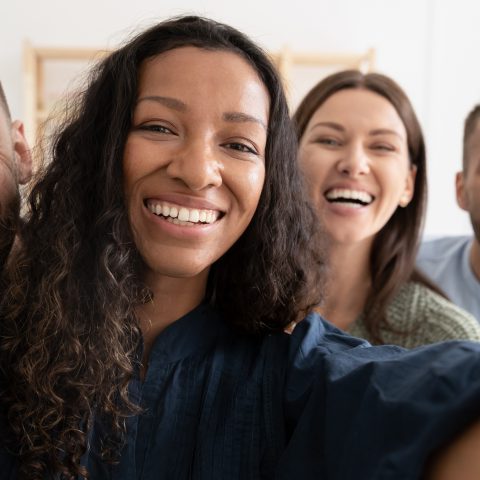 Group of young diverse adults taking a selfie