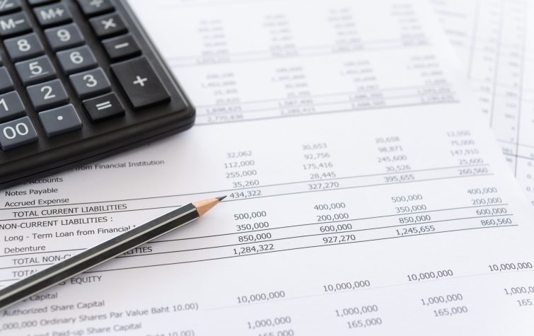 balance sheet and calculator on desk.