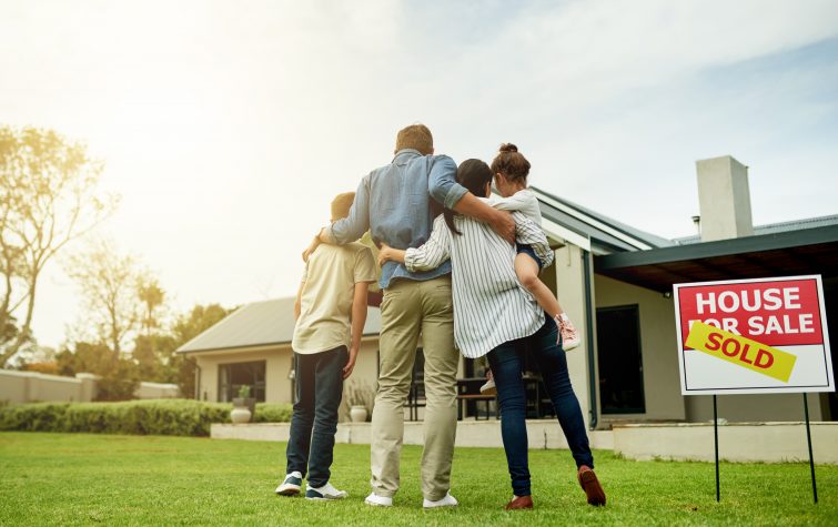 Shot of a family of four viewing their new home