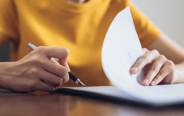 Woman signing document