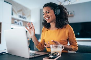 Remote worker smiling and talking during a virtual meeting