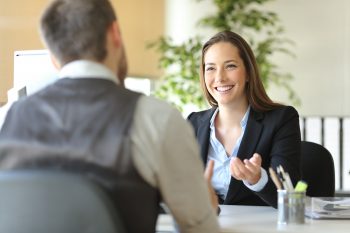 Two business people speaking to each other