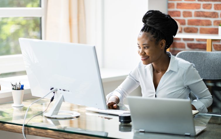 Happy Professional Woman Employee Using Computer For Work