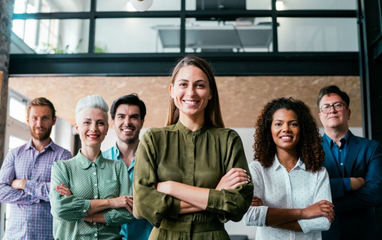 Smiling businesswoman standing with her successful team