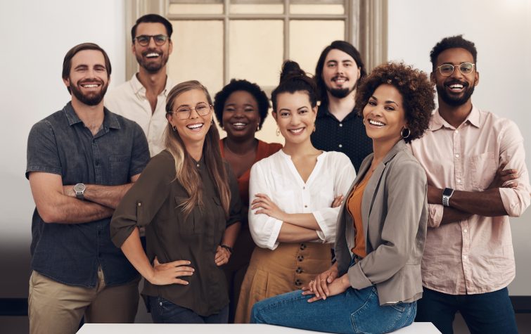 Portrait of a group of smiling businesspeople standing together in an office