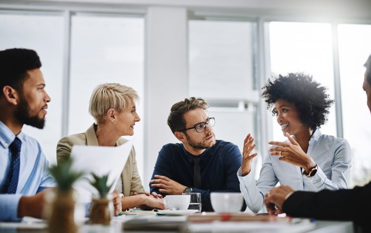 A group of businesspeople sitting together in a meeting