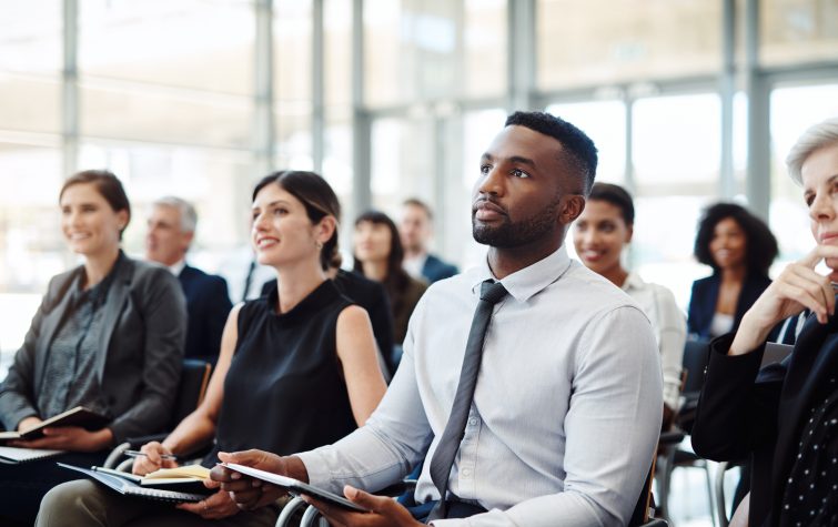 Shot of a group of businesspeople attending a conference