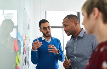 Multi-ethnic business people discussing during a brainstorm session for their small company