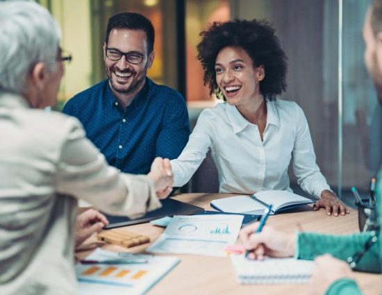 Businesswomen shaking hands in the office