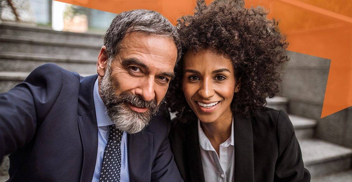 Corporate man and woman sitting on stairs
