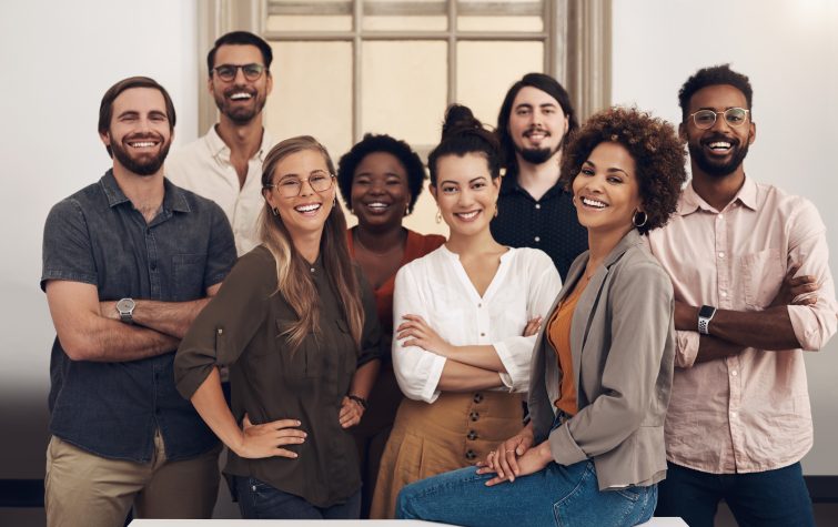 Portrait of a group of smiling businesspeople standing together in an office