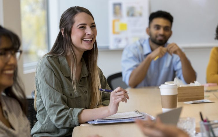 Diverse young adult coworkers in a meeting at office