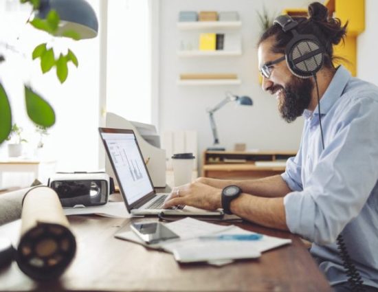 Young professional male working at home office