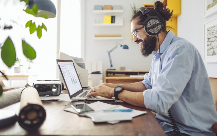 Young professional male working at home office