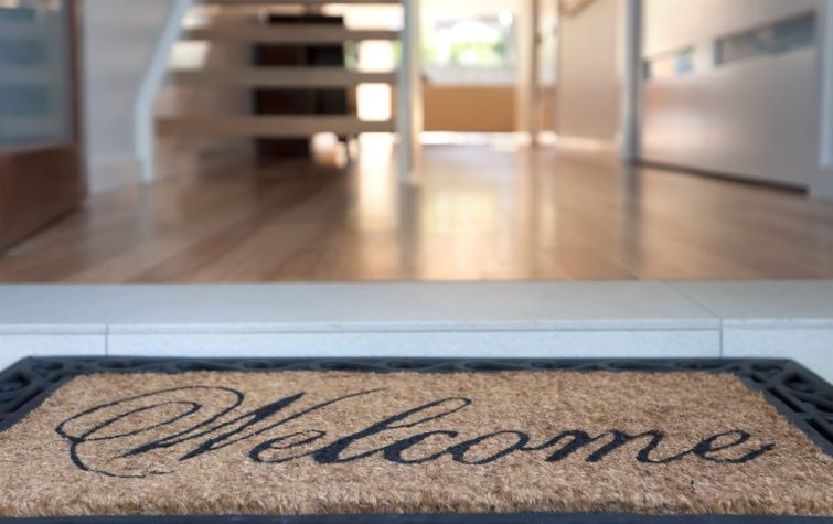 House entryway with a welcome mat displayed
