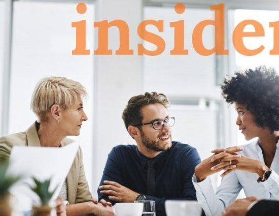 Diverse group of coworkers meeting around table