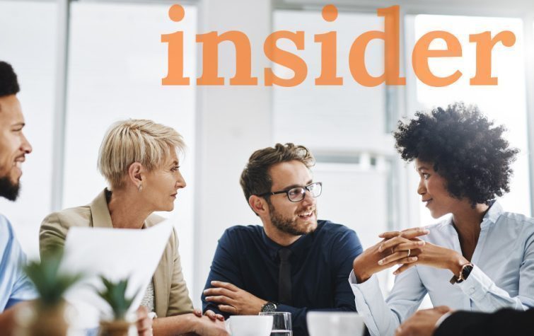 Diverse group of coworkers meeting around table