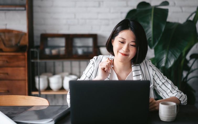 Young Asian woman having online meeting at home office