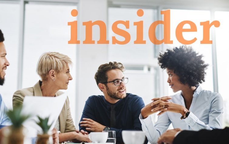 Team meeting around table with the word insider