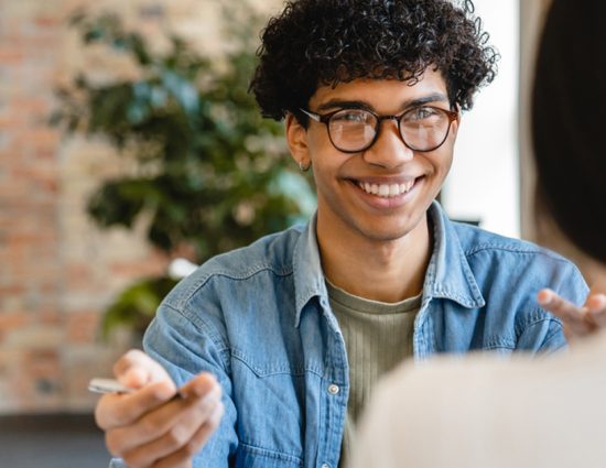 Young man meeting with woman across table