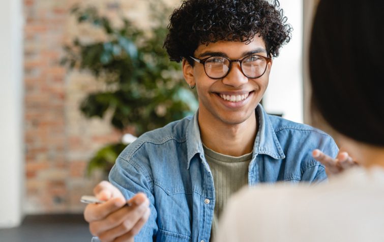 Young man meeting with woman across table