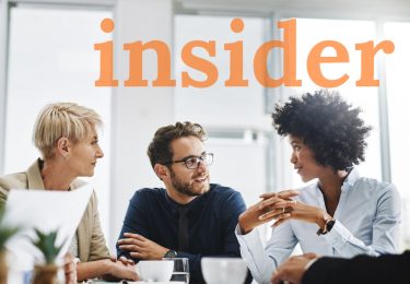 Team meeting around table with the word insider