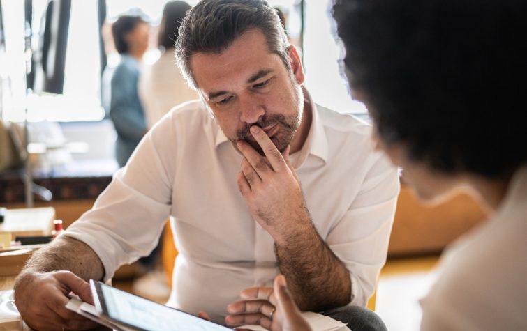 Man and women meeting looking at ipad