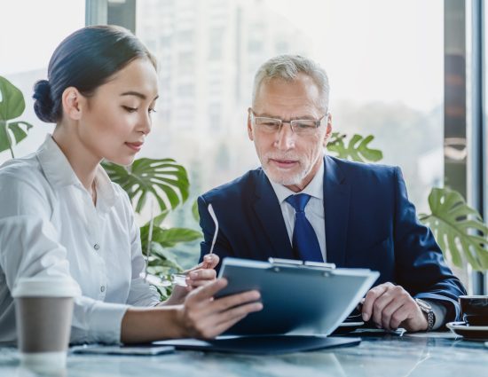 Woman at the office showing a document to a man