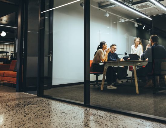 4 co-workers sitting around a table