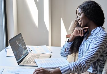 Woman smiling on team video call