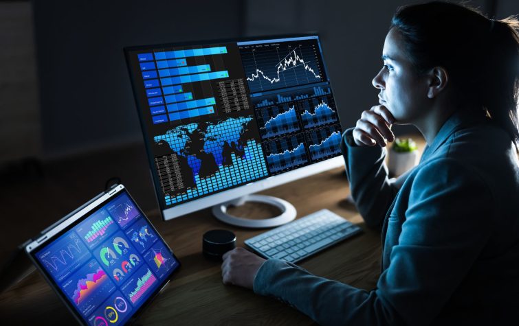 Woman looking at data on a desktop computer