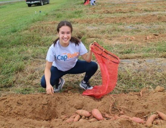 girl smiling while working at the farm