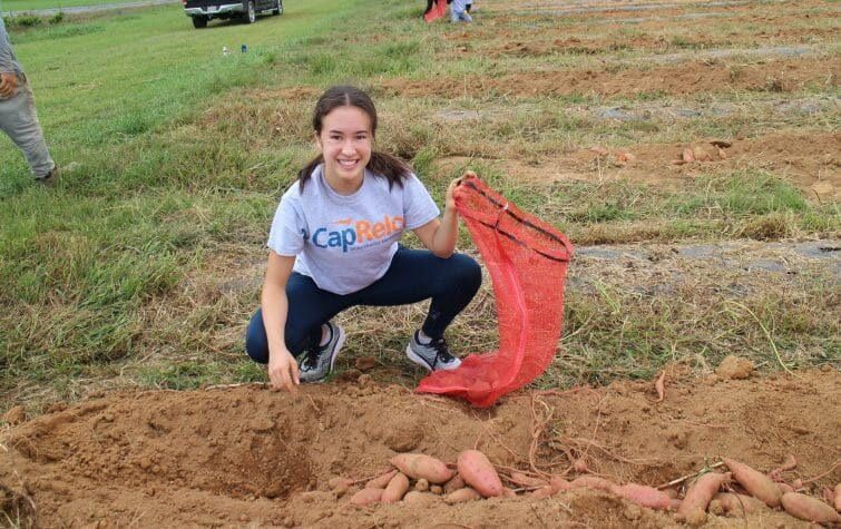 girl smiling while working at the farm