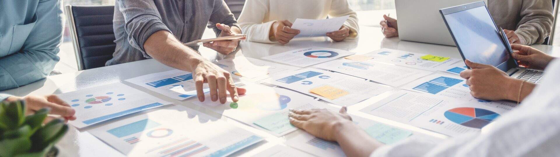 Coworkers gathered around table with data reports