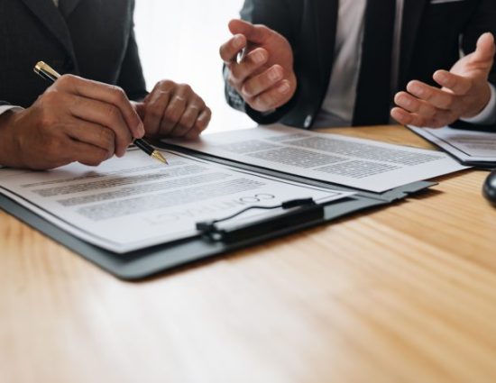 employee reviews employee agreement with HR at a desk