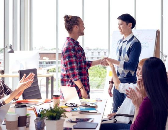 conference room meeting during orientation, new employee shakes hands with manager