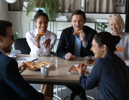 employees eating pizza in an office