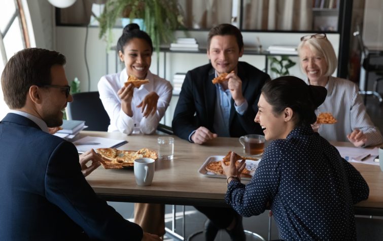 employees eating pizza in an office