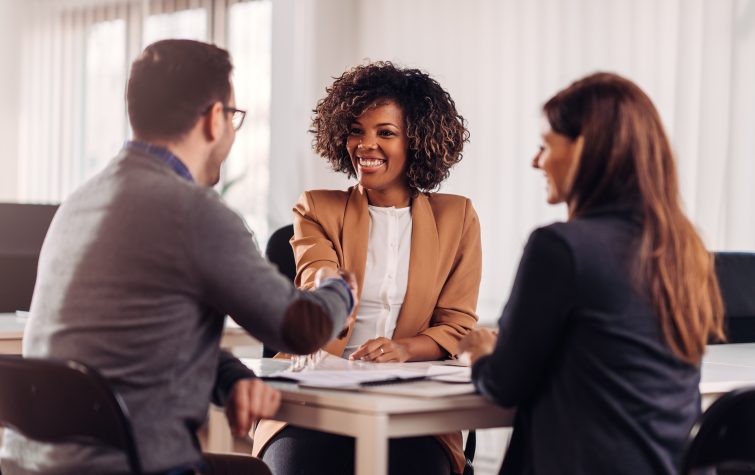 candidate shakes hands with employees in interview