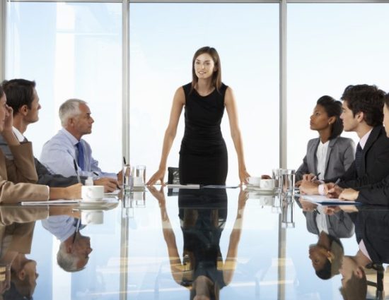 employees at a conference table in a corporate office