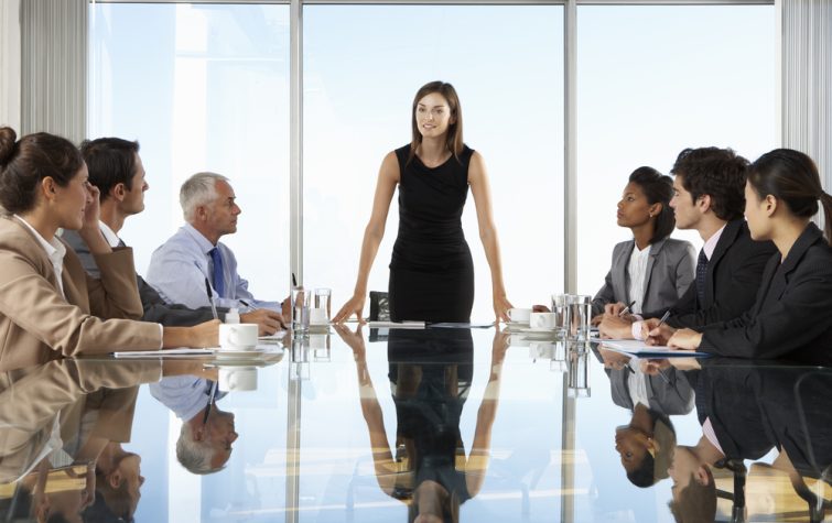 employees at a conference table in a corporate office