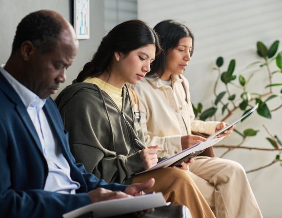 Employees reviewing immigration and visa application documents before an international relocation assignment