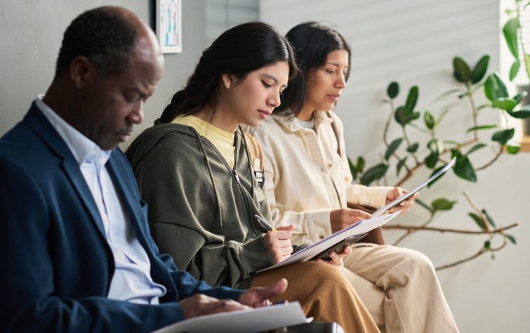Employees reviewing immigration and visa application documents before an international relocation assignment