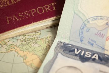 Passport pages covered in international visa and immigration stamps