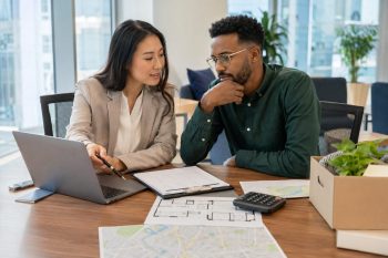 Mobility consultant reviews a relocation budget and housing checklist with an employee