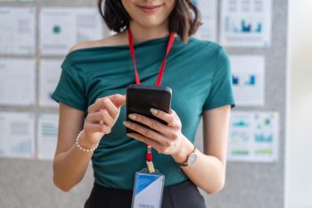 Professional woman checking her relocation timeline and move updates on a smartphone