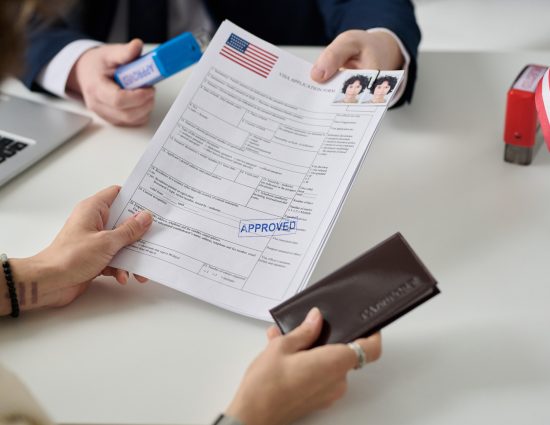 Woman obtaining a U.S. visa at an immigration office representing the growing visa complexity driving outbound global mobility programs