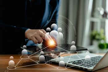 HR manager using a digital tablet with a world map interface to review global talent strategy and outbound mobility destinations